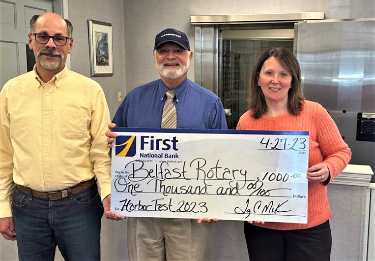 First National Bank presented a $1,000 charitable gift check to Belfast Rotary Club in support of the
August 2023 Belfast Harbor Fest. The bank is a “Ship Owner” sponsor of the event, sponsor of both
the August 19 Harbor Fest “Bug Run” 5K road race and a Harbor Fest National Boatbuilding
Challenge team. Left to right are Edward Varney of First National Bank, Mickey Sirota from Belfast
Rotary Club, and Michelle MacKay of First National Bank. (Photo courtesy First National Bank)